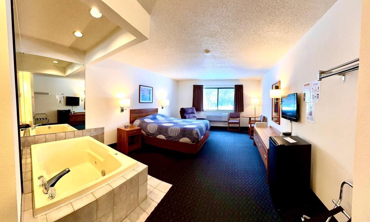 Boulder Junction Apartment | One queen bed, private bathroom, two-person whirlpool tub, mini fridge, and single-serve coffee maker.