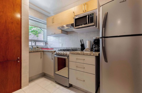 Anahuac Condo | Capitalia | Bright balcony + Bike & Leafy Views