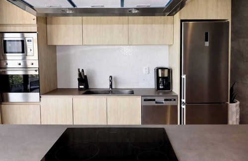 Tulum Condo | Enjoy Tulum from this 1BR apartment at TUK TULUM by HeusHaven, ideal for up to 4 guests. It features a king bed, queen sofa bed, fully equipped kitchen, private balcony, and access to rooftop pools, paddle tennis courts, parking, and 24/7 security.