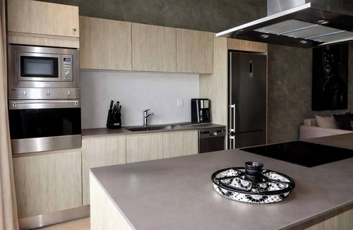 Tulum Condo | Enjoy Tulum from this 1BR apartment at TUK TULUM by HeusHaven, ideal for up to 4 guests. It features a king bed, queen sofa bed, fully equipped kitchen, private balcony, and access to rooftop pools, paddle tennis courts, parking, and 24/7 security.