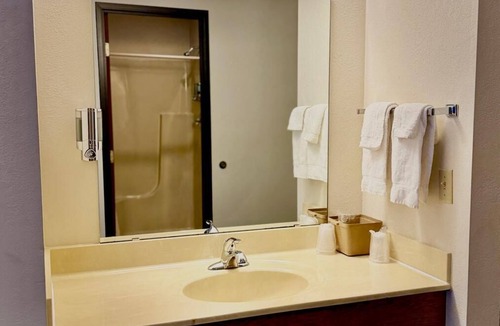 Boulder Junction Apartment | One queen bed, private bathroom, two-person whirlpool tub, mini fridge, and single-serve coffee maker.