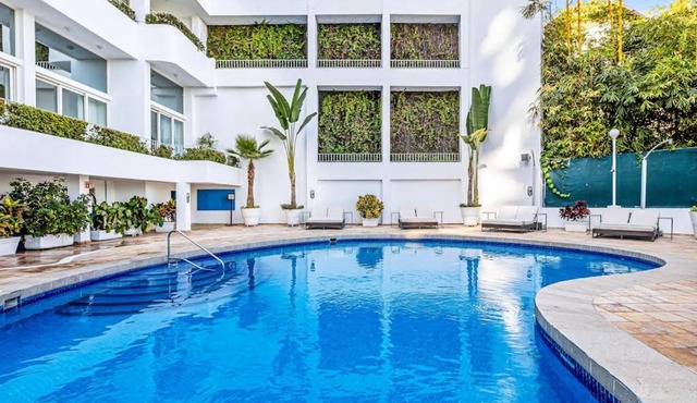 Modern hillside suite with balcony, city view, pools, gym & full kitchen